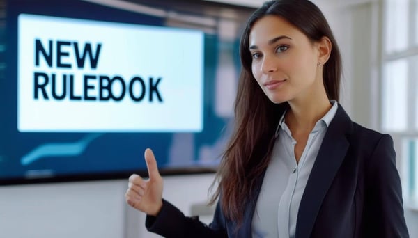 A business women presenting a screen that says NEW RULEBOOK